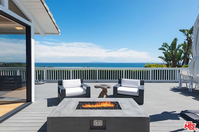 a outdoor living space with patio furniture and garden view