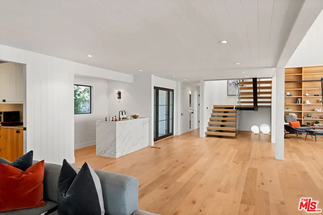 an empty room with wooden floor and furniture