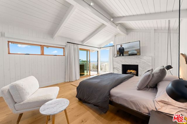 a bed room with two beds and a fireplace