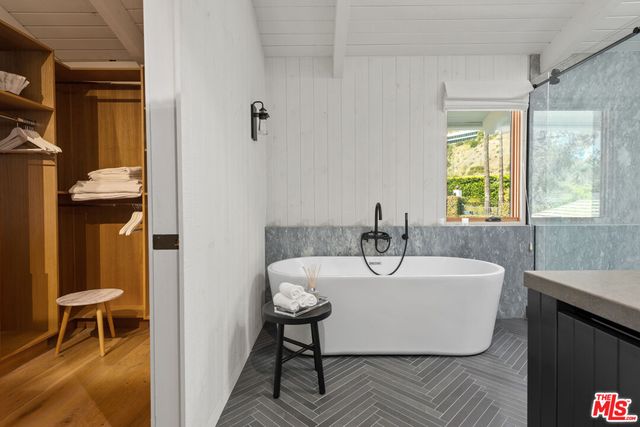 a bedroom with furniture and a flat screen tv