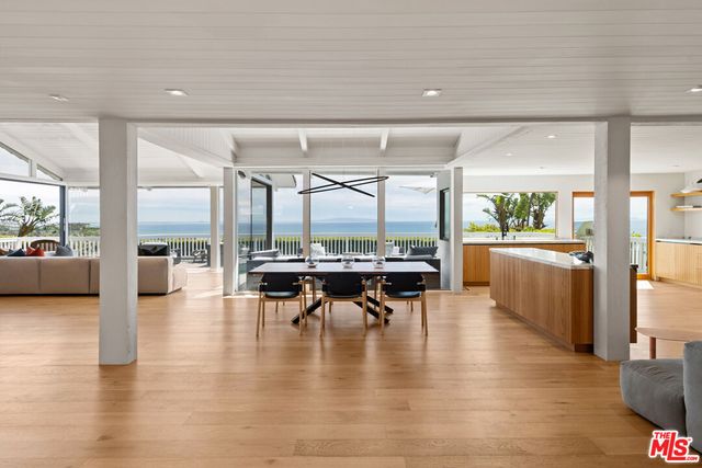 a dining room with furniture and wooden floor