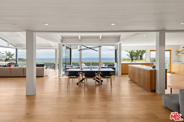 a dining room with furniture and wooden floor