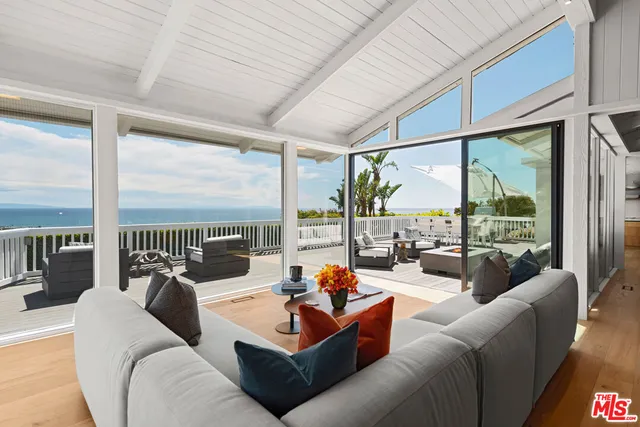 a living room with furniture city view and a floor to ceiling window