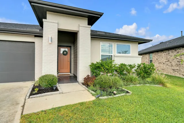 a front view of a house with garden