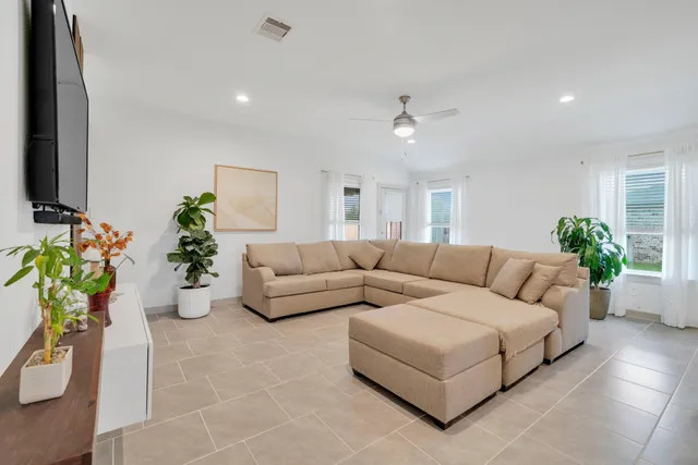 a living room with furniture potted plant and a window