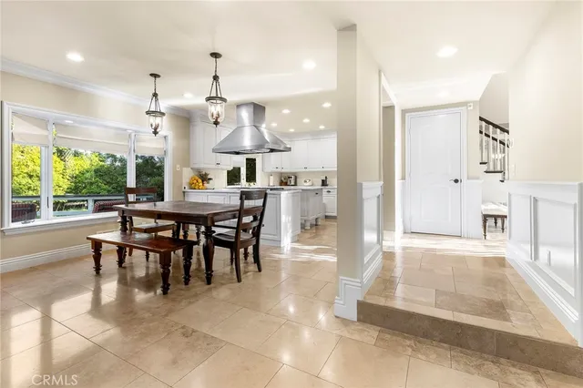 a bed sitting in a spacious bedroom next to a window