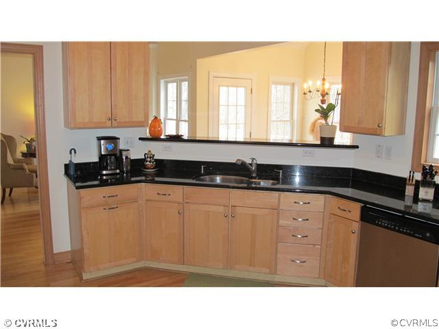 2545 Lochness Road Richmond, VA 23235 - Photo 5 of 20 a kitchen with a sink window and cabinets