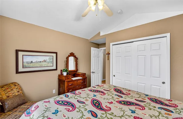 a bedroom with a bed and a dresser in it