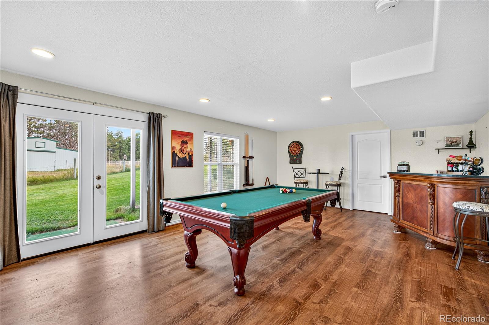 2464 Remington Road Elizabeth, CO 80107 - Photo 21 of 41 a room with furniture pool table wooden floor and windows