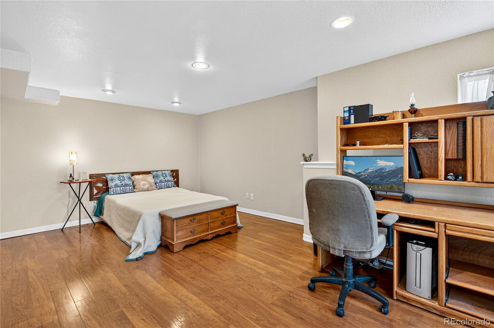 2464 Remington Road Elizabeth, CO 80107 - Photo 26 of 41 a bedroom with furniture and a wooden floor