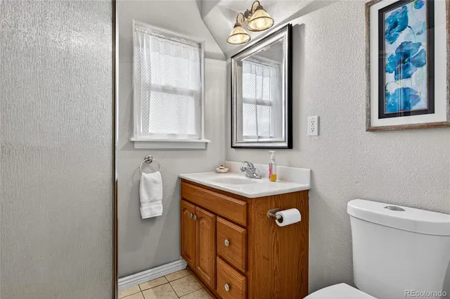 a bathroom with a toilet a sink and a window