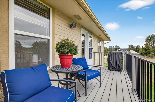 a view of balcony with wooden floor and outdoor seating