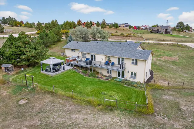 a aerial view of a house with a yard and a fountain