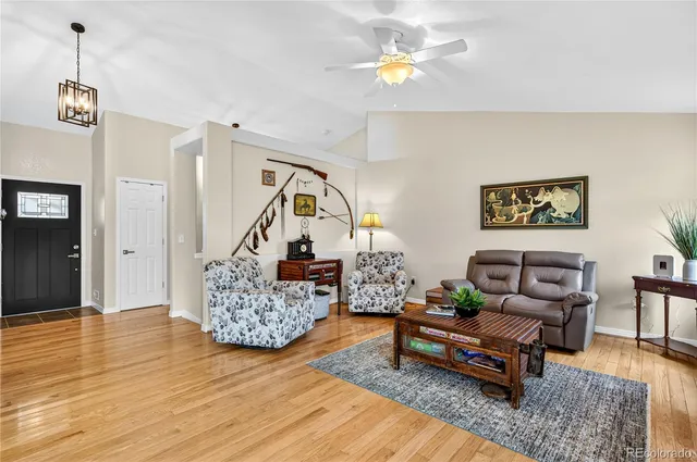 a living room with furniture and wooden floor