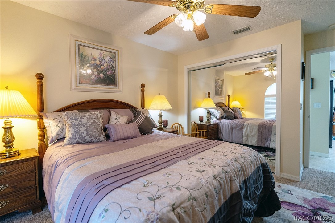 800 Balmoral Court Inverness, FL 34453 - Photo 29 of 72 a bedroom with double bed and a chandelier