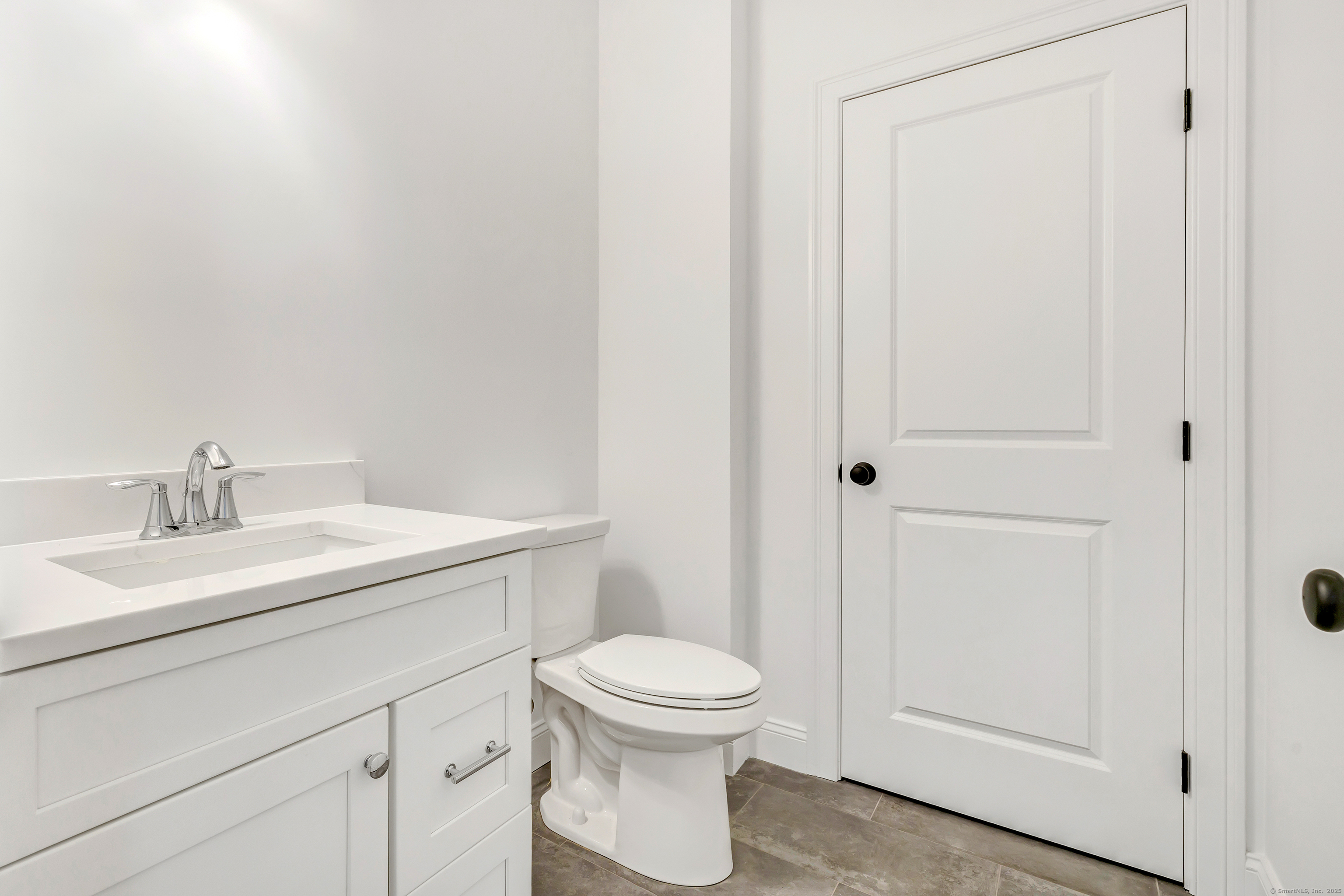 5 Windward Way, Unit 5 Waterford, CT 06385 - Photo 3 of 6 a bathroom with a toilet a sink and a mirror