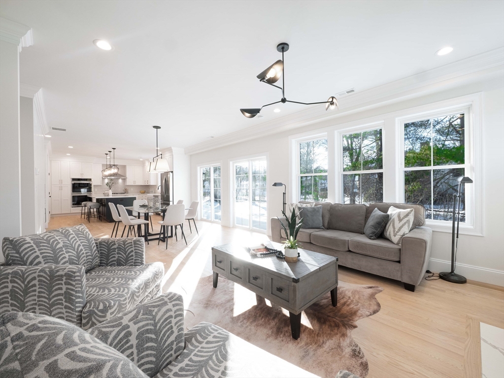 22 Bradford Road Natick, MA 01760 - Photo 11 of 37 a living room with furniture and view of kitchen