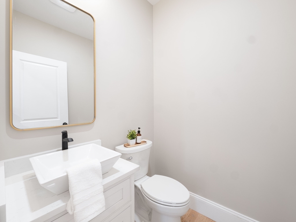 22 Bradford Road Natick, MA 01760 - Photo 16 of 37 a bathroom with a sink a toilet and mirror