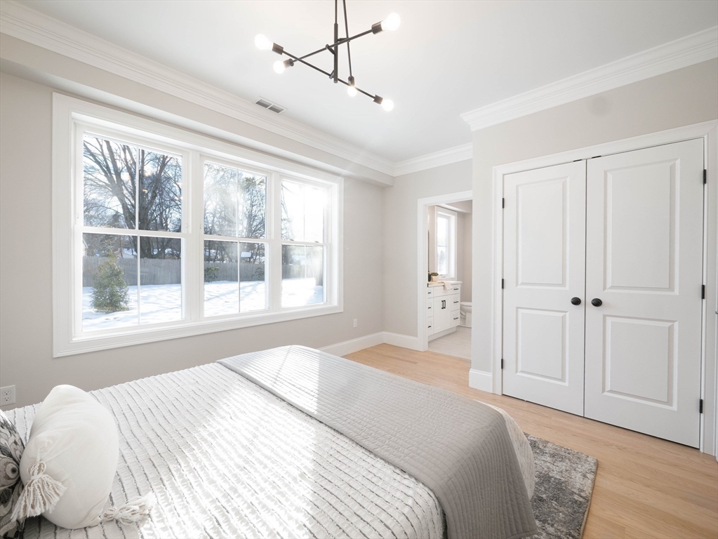 22 Bradford Road Natick, MA 01760 - Photo 18 of 37 a bedroom with a bed and a window