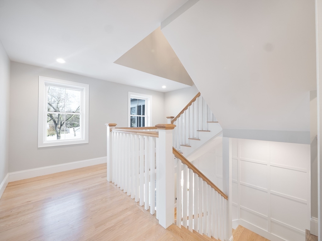 22 Bradford Road Natick, MA 01760 - Photo 20 of 37 a view of entryway with wooden floor and stairs