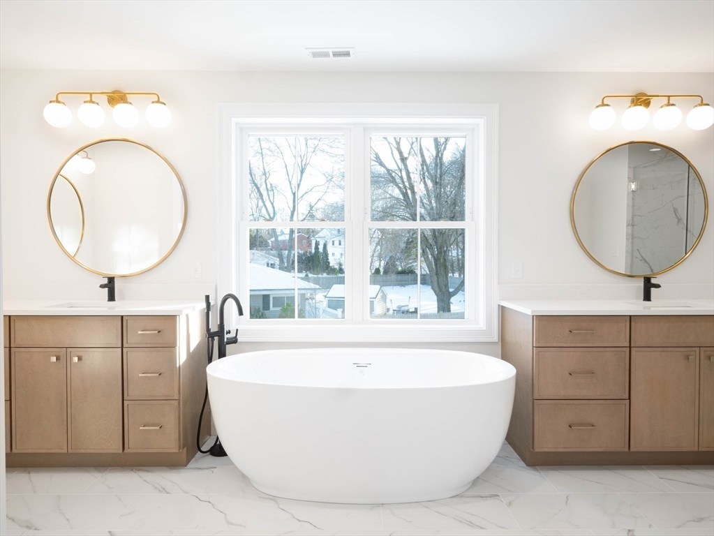 22 Bradford Road Natick, MA 01760 - Photo 23 of 37 a living room with a mirror and a sink