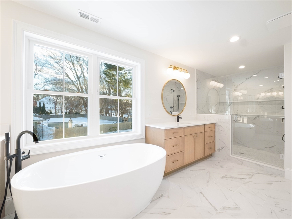 22 Bradford Road Natick, MA 01760 - Photo 24 of 37 a large spacious bathroom with a large tub sink and vanity