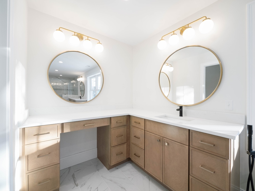 22 Bradford Road Natick, MA 01760 - Photo 25 of 37 a bathroom with a granite countertop a double vanity sink and a mirror