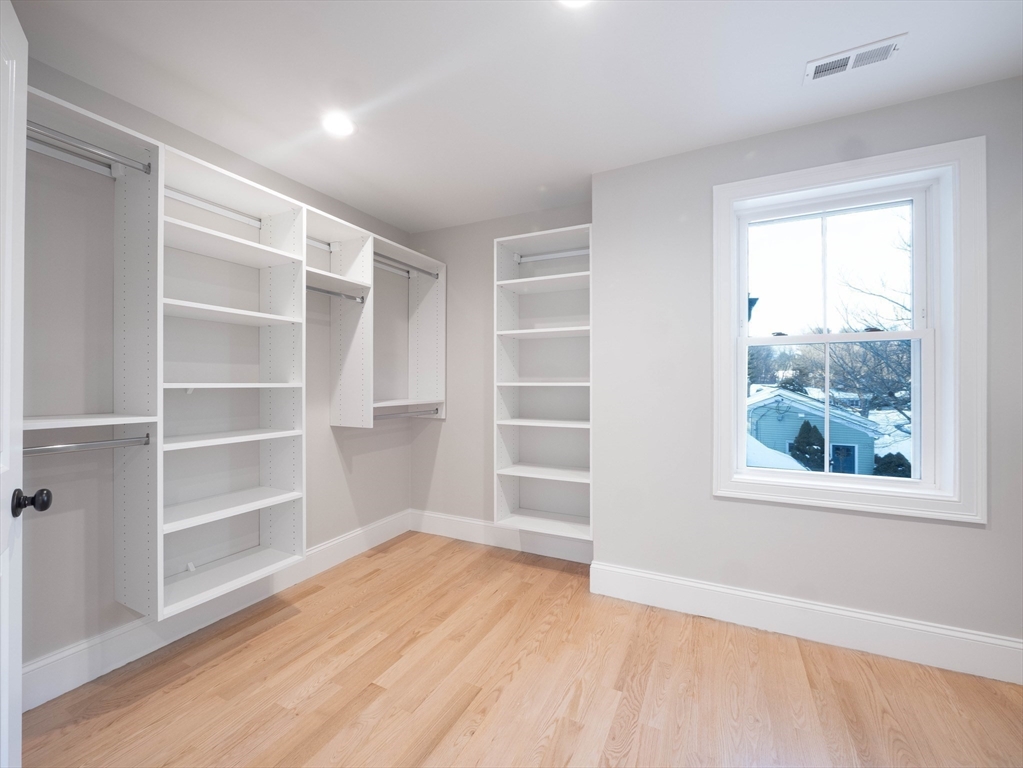 22 Bradford Road Natick, MA 01760 - Photo 27 of 37 a view of an empty room with a window and wooden floor