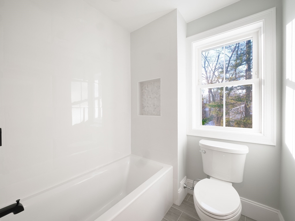 22 Bradford Road Natick, MA 01760 - Photo 31 of 37 a white toilet sitting next to a window