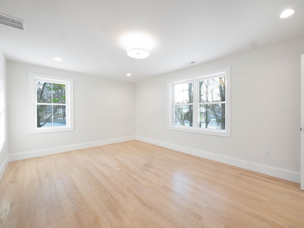22 Bradford Road Natick, MA 01760 - Photo 35 of 37 an empty room with wooden floor and windows