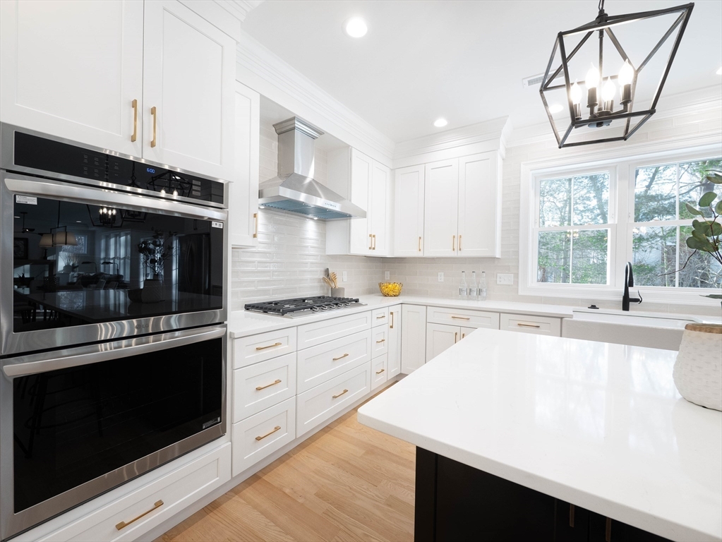 22 Bradford Road Natick, MA 01760 - Photo 4 of 37 a kitchen with stainless steel appliances granite countertop a stove a sink and a microwave