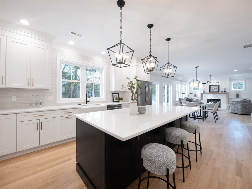 22 Bradford Road Natick, MA 01760 - Photo 6 of 37 a large kitchen with a table and chairs