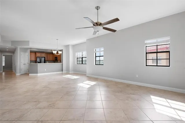 a view of an empty room with a window and fireplace