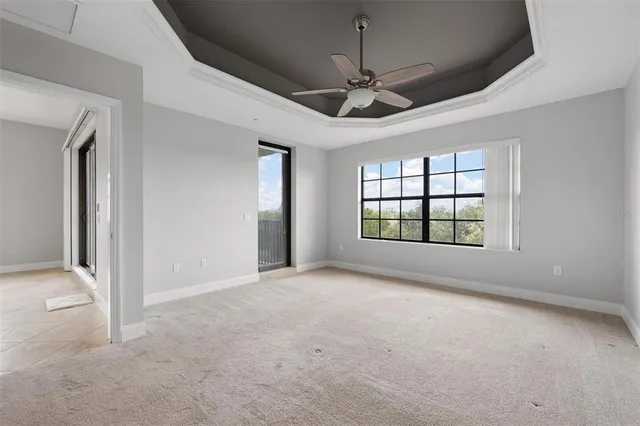 en empty room with windows and ceiling fan