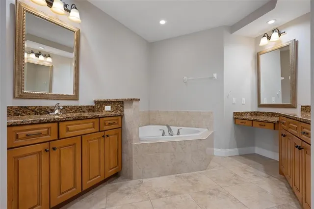 an empty room with a chandelier fan and closet area