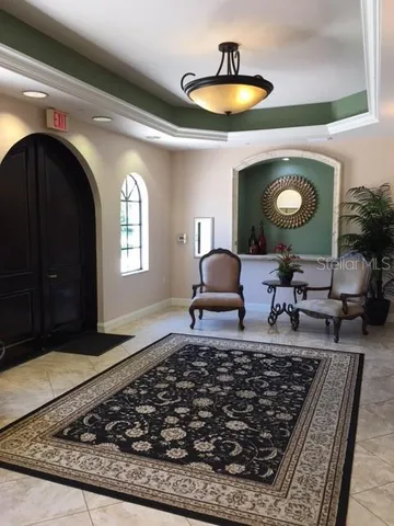 a living room with a rug and a lamp