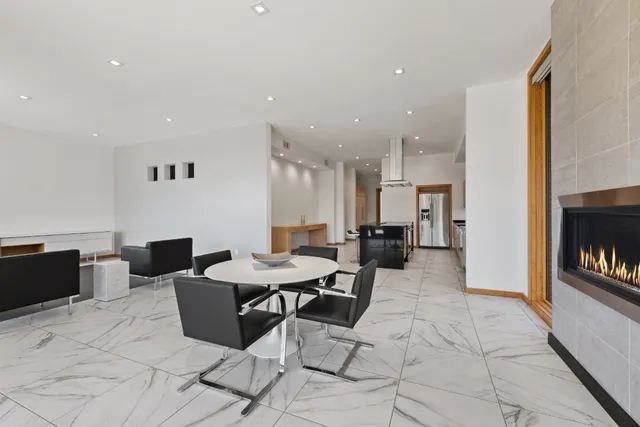 a living room with furniture a flat screen tv and kitchen view