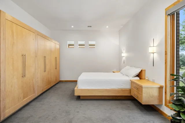 a spacious bedroom with a bed and a window