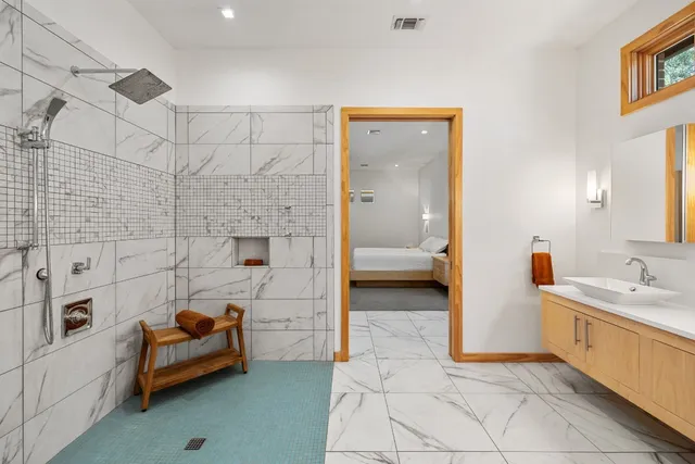 a bathroom with a tub and a view of bathroom