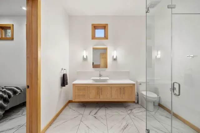 a spacious bathroom with a tub sink and mirror