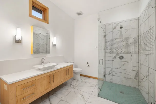 a bathroom with a double vanity sink mirror and shower