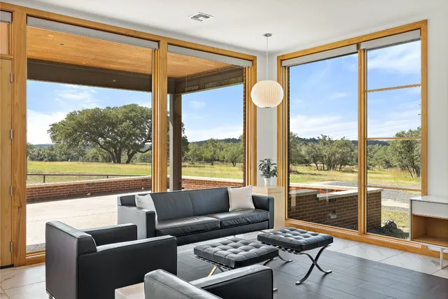a living room with a large window and a table