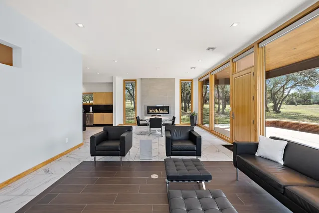 a living room with furniture and large windows