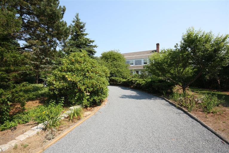 58 Old Salt Works Road Chatham, MA 02633 - Photo 13 of 15 a view of a garden with plants and a building in the background