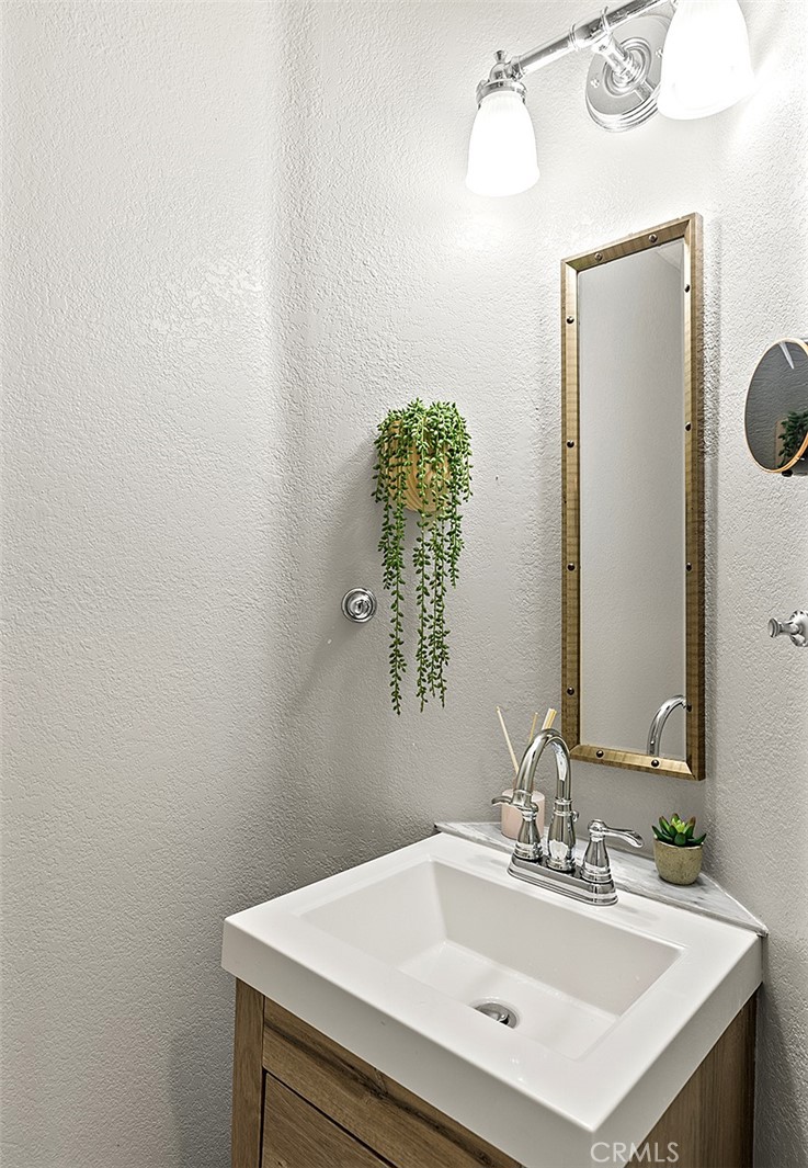 23966 Wanigan Way Laguna Niguel, CA 92677 - Photo 12 of 57 a bathroom with a sink vanity and a mirror