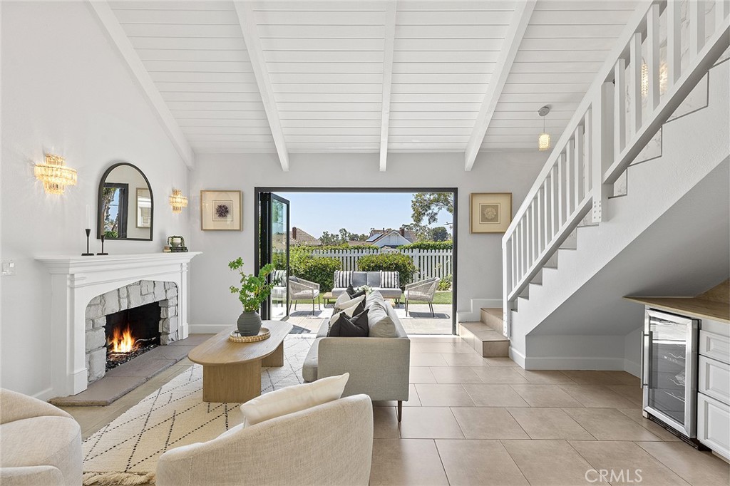 23966 Wanigan Way Laguna Niguel, CA 92677 - Photo 16 of 57 a living room with furniture a fireplace and a floor to ceiling window