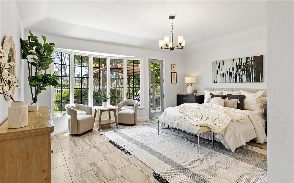 23966 Wanigan Way Laguna Niguel, CA 92677 - Photo 23 of 57 a spacious bedroom with a large bed and a chandelier