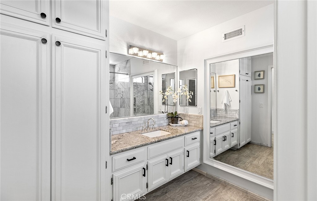 23966 Wanigan Way Laguna Niguel, CA 92677 - Photo 34 of 57 a bathroom with a granite countertop sink mirror and shower