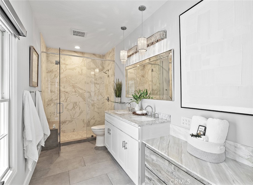 23966 Wanigan Way Laguna Niguel, CA 92677 - Photo 37 of 57 a spacious bathroom with a double vanity sink mirror and a bathtub