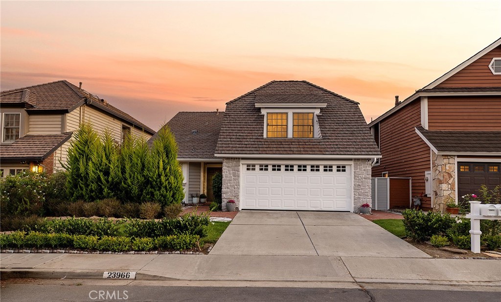 23966 Wanigan Way Laguna Niguel, CA 92677 - Photo 47 of 57 a front view of a house with a yard and garage